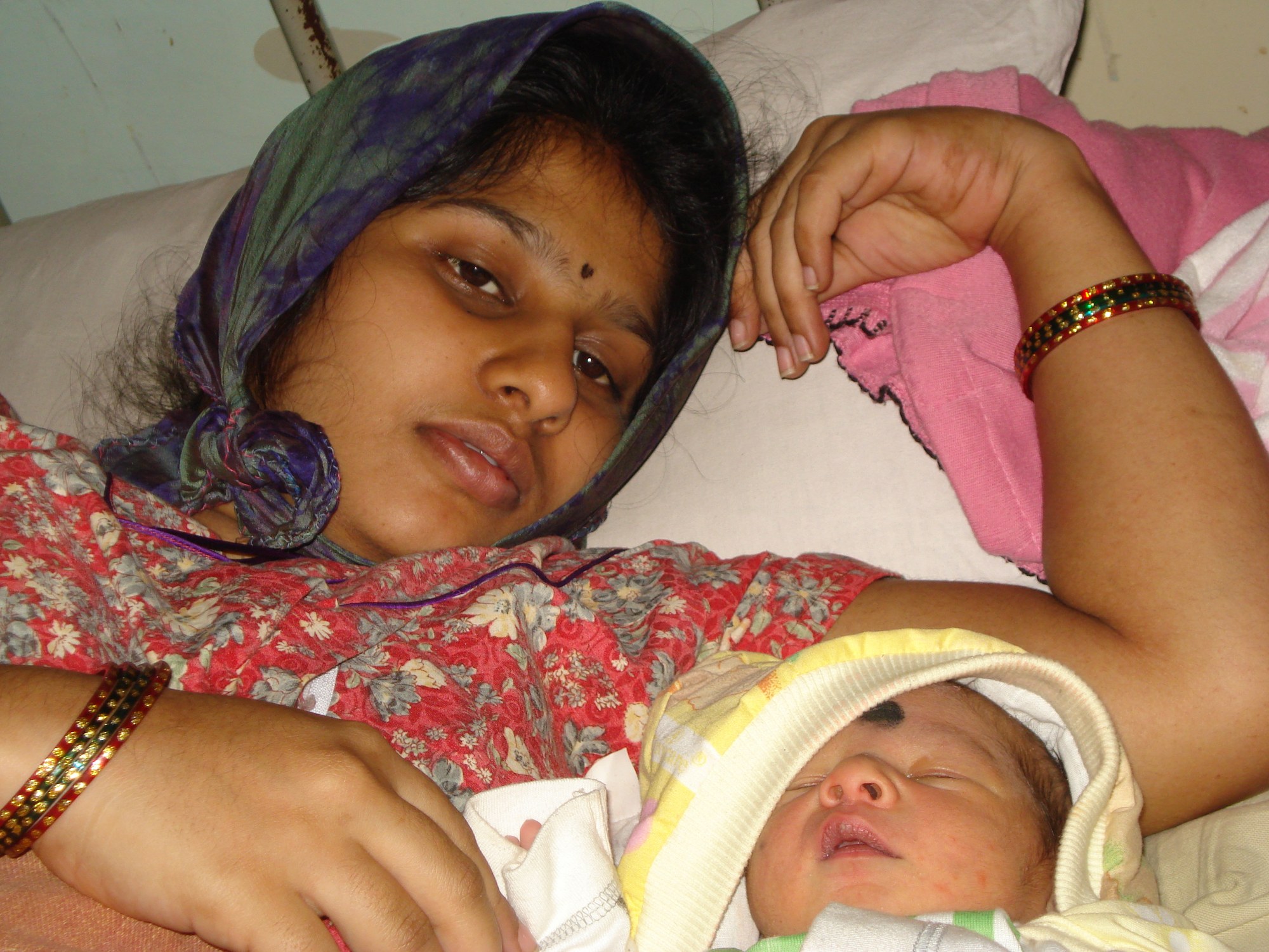 A mother resting with her newborn shortly after birth