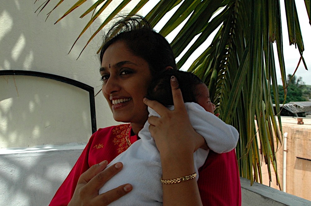 A counsellor taking a call while holding a baby