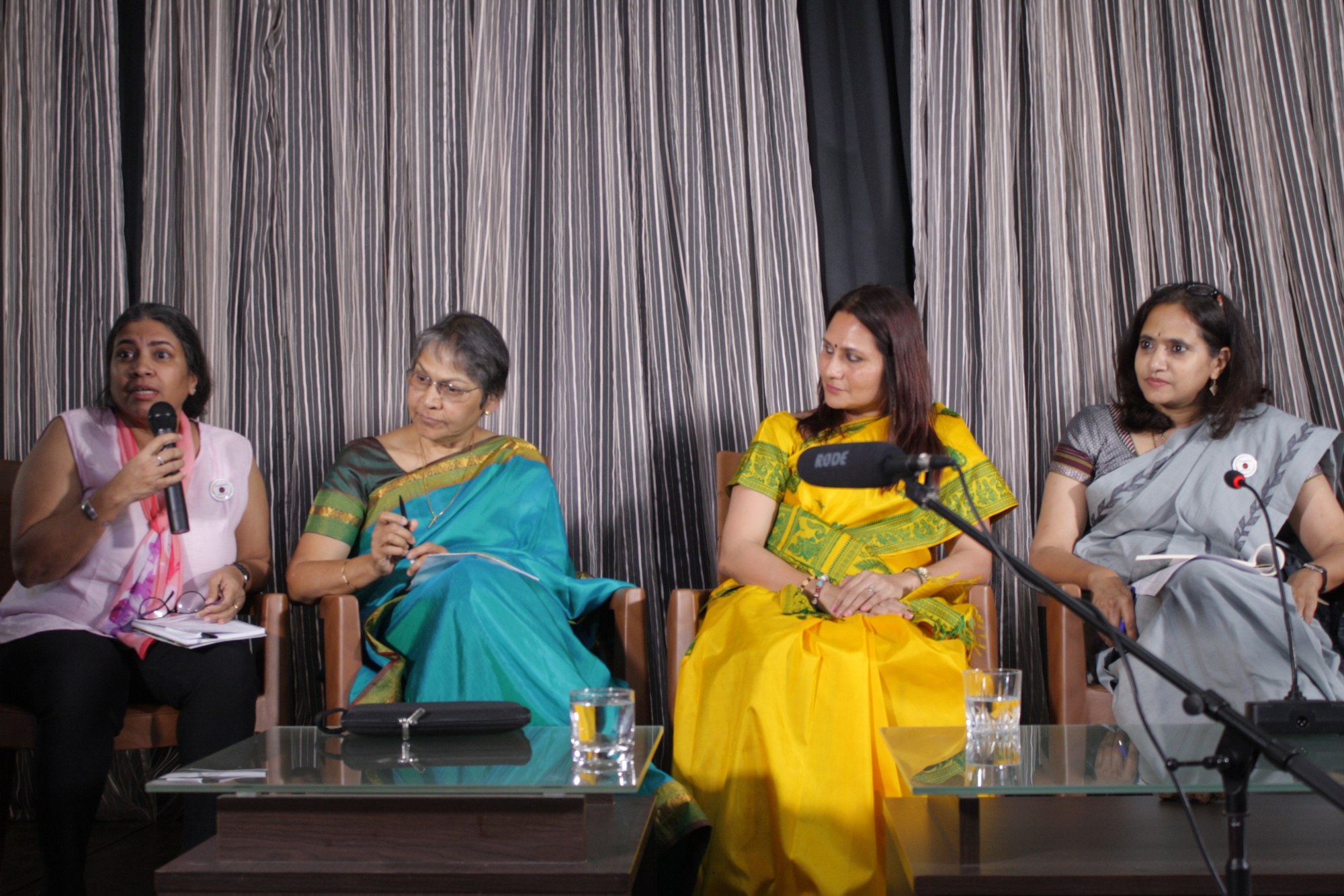Speakers seated on stage at a Bangalore Birth Network panel discussion