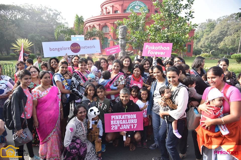 A large group of women walking with placards for maternal health awareness
